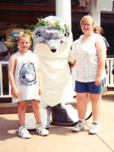 Becky and cousin with dolphin cast member at SeaWorld, Orlando, FL