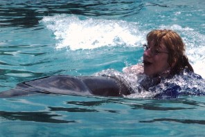 Chelsie riding a dolphin at Discovery Cove, Orlando, FL